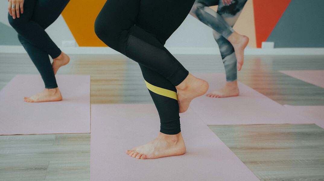 Small group doing a guided stretching session in a studio