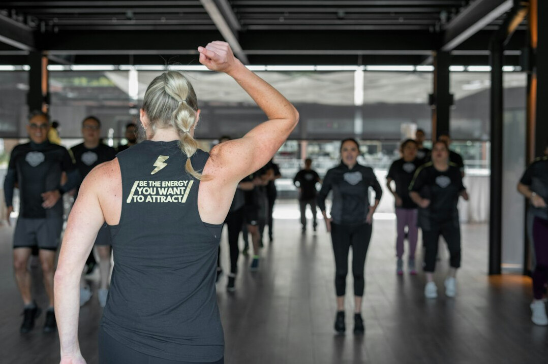 Instructor guiding a small group through a movement exercise