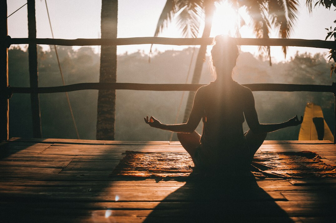 person meditating in morning light