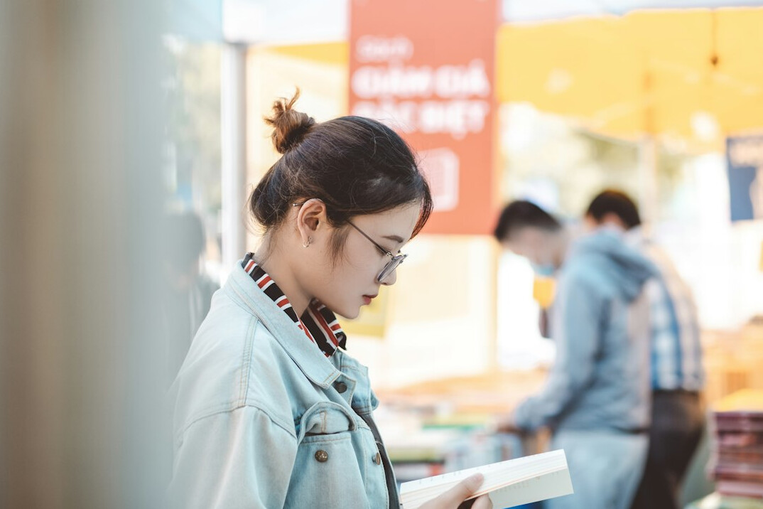 elderly person reading book